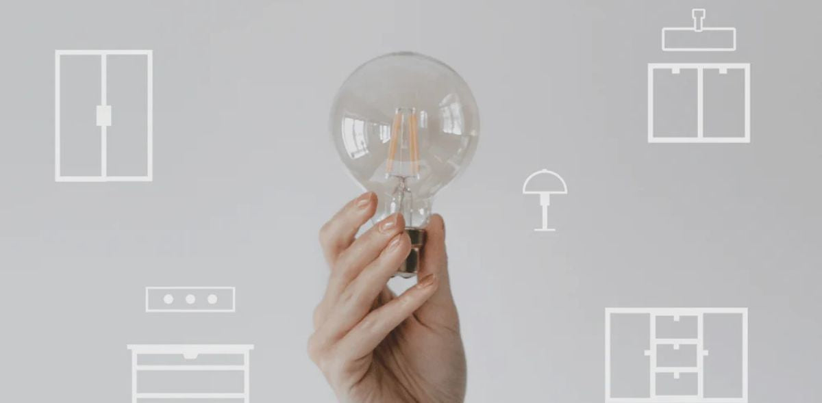 Hand hält eine Glühbirne hoch